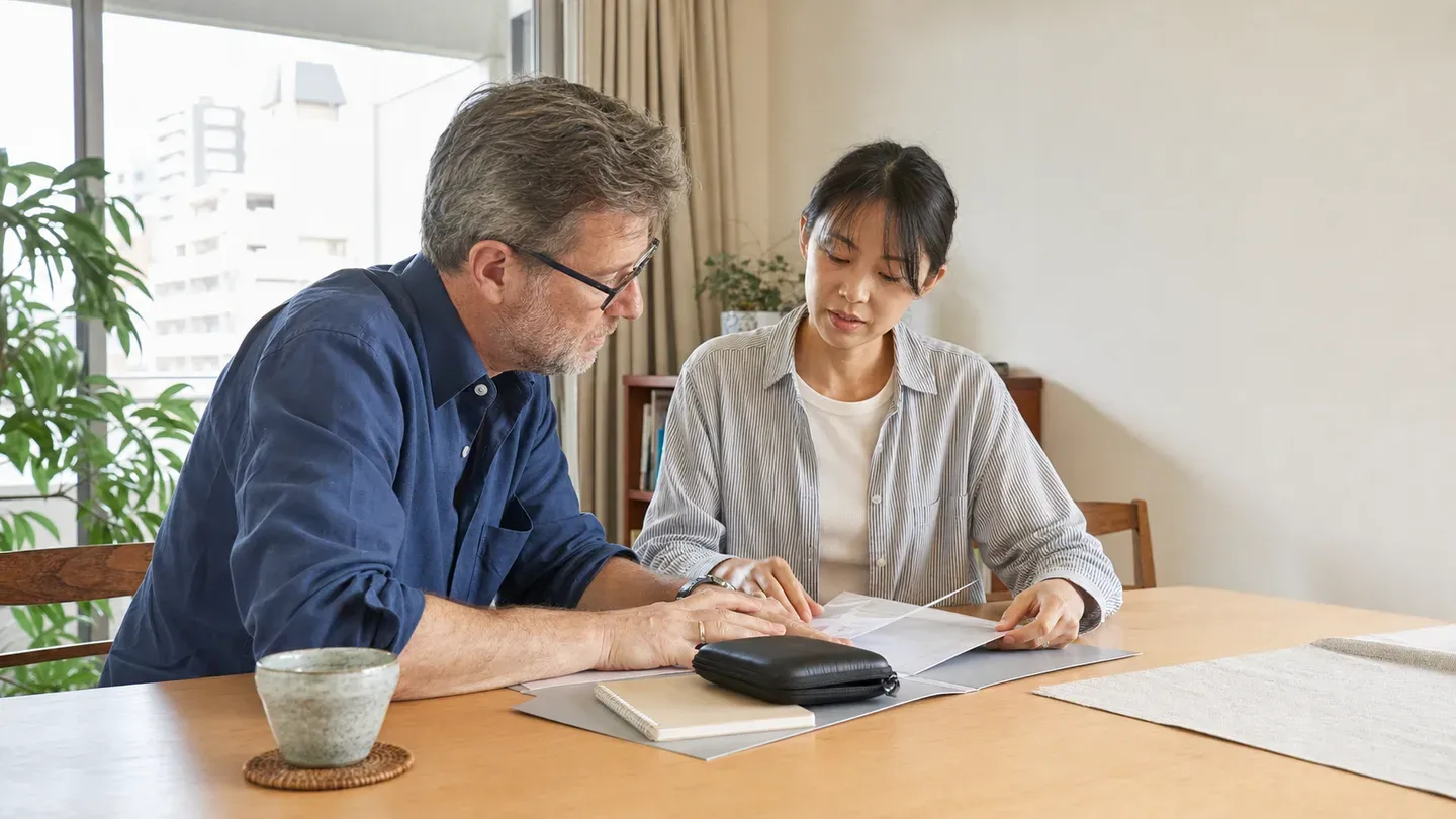 An international patient and coordinator preparing records and travel documents together